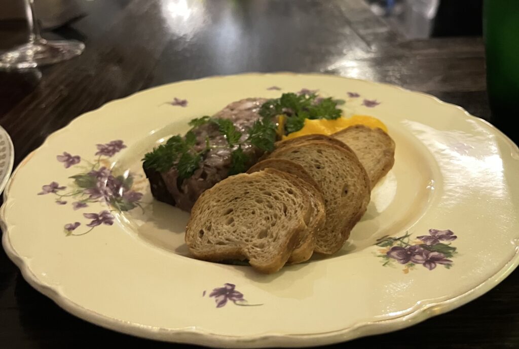 Rabbit terrine with croutons on retro patterned plate